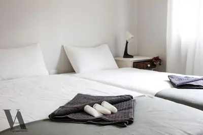 two beds with towels on them in a bedroom at Voga Apartments Sta Catarina in Porto