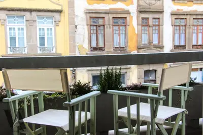 two chairs sitting on top of a balcony at Voga Apartments Sta Catarina in Porto