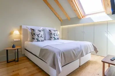 a bedroom with a large bed and a window at My homey at Flores in Porto