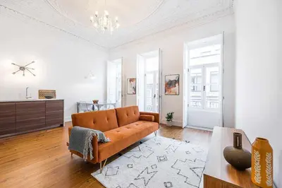 a living room with a couch and a table at Classic Bonjardim in Porto