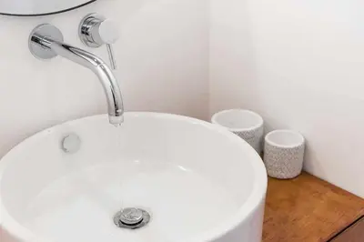 a white sink with a faucet in a bathroom at Classic Bonjardim in Porto