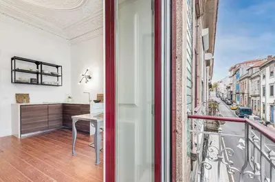 an apartment with a balcony with a desk at Classic Bonjardim in Porto