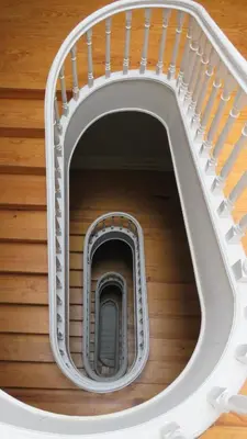 a spiral staircase in a building with a stair case at Porto Republica Ribeira in Porto