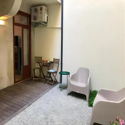 a room with a table and chairs and a building at Pateo Loft in Porto