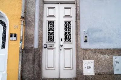 a white door on the side of a building at Blue Studio perto do metro - Cedofeita, Porto in Porto
