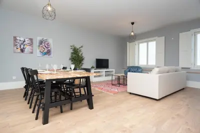 a living room with a table and chairs and a couch at Porto XL in Porto