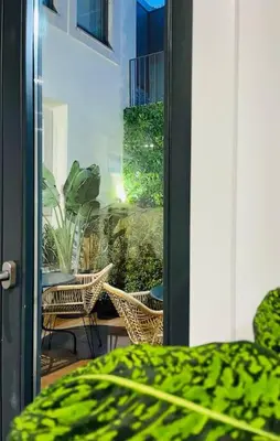 an open door to a patio with chairs and a table at Apartamento central, junto a Praça da Batalha - APT F in Porto