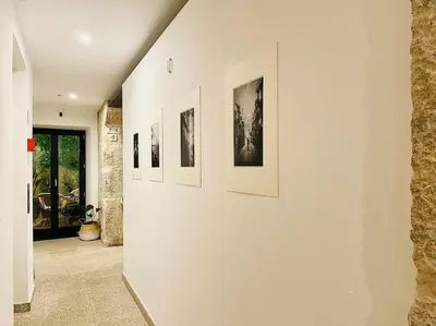 a hallway with a row of pictures on a wall at Lindo apartamento em zona central, Batalha - Porto - APT L in Porto