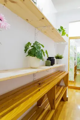 a wooden bench in a room with potted plants at Travel & Live Nature in Porto