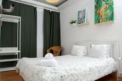 a bedroom with a bed with a green curtain at Travel & Live Nature in Porto