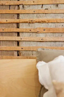 a wooden wall with a chair in front of it at Porto Sé Apartamentos in Porto