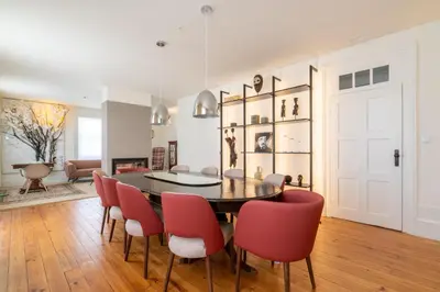 a dining room with a table and red chairs at FONTE SANTA Manor House in Vila Nova de Gaia