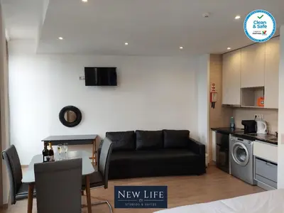 a hotel room with a bed and a table and chairs at New Life - CASA MÚSICA SUITE-2F in Porto