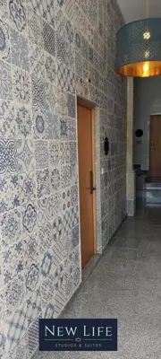 a lobby with a new life sign on a tiled wall at New Life - FUNDAÇÃO SERRALVES STUDIO-0F in Porto