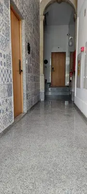 a hallway of a building with a door and a tile floor at New Life - SÉ CATEDRAL STUDIO - 1T in Porto
