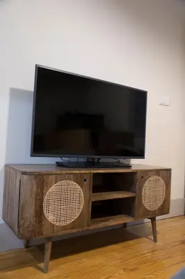 a flat screen tv sitting on top of a wooden entertainment center at TOP Porto in Porto