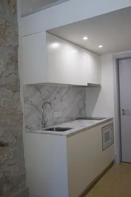 a kitchen with white cabinets and a sink at TOP Porto in Porto