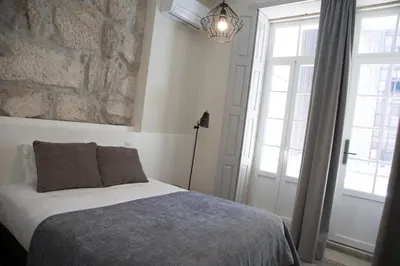 a bedroom with a bed and a large window at TOP Porto in Porto