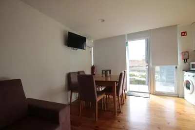 a kitchen and dining room with a table and chairs at OPORTO GUEST Natária Flats with Parking in Porto