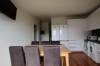 a kitchen with a dining room table and chairs at OPORTO GUEST Natária Flats with Parking in Porto