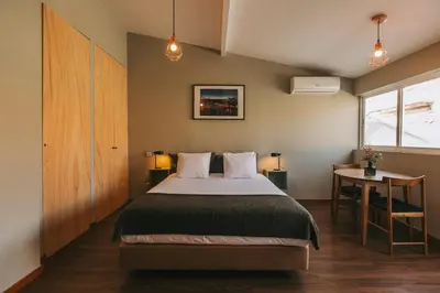 a bedroom with a bed and a table and a window at Oporto Maison Sol in Porto
