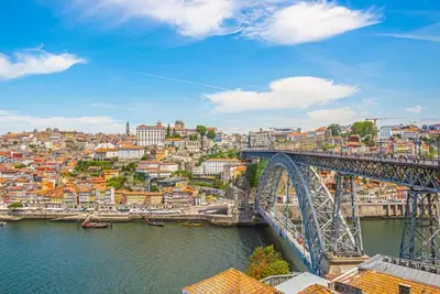 a bridge over a river next to a city at Luxury in the Art District by Innkeeper in Porto