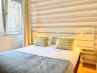 a bedroom with a large bed with two pillows at Apartments Porto Historico in Porto