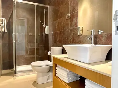 a bathroom with a sink and a toilet and a shower at Apartments Porto Historico in Porto