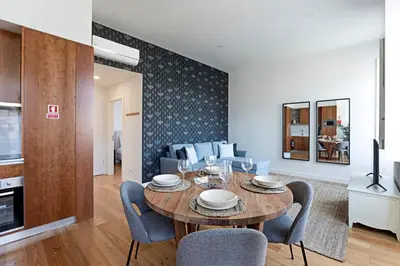 a dining room and living room with a table and chairs at Monte dos Judeus 26 by LovelyStay in Porto
