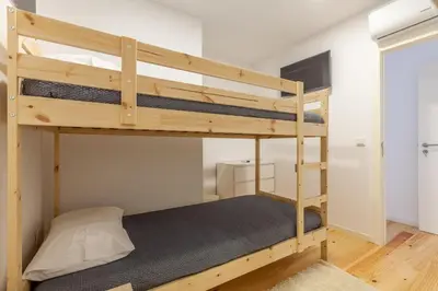 a bedroom with two bunk beds in a room at Villa Apartments & Suites in Porto