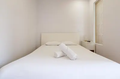 a white bed with two pillows on it at GuestReady - Bolhão Market Place in Porto