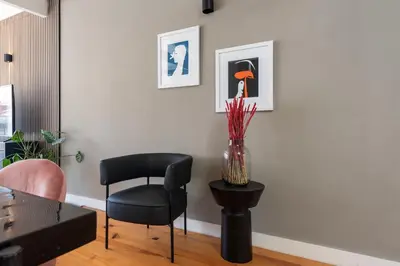 a living room with a chair and a table at The Mouzinho Penthouse in Porto