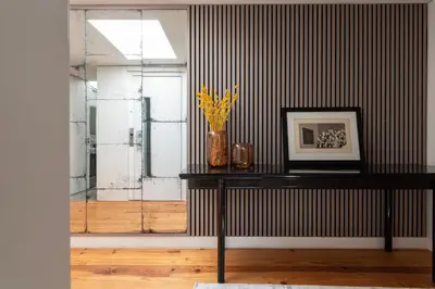 a room with a table with a picture and a vase at The Mouzinho Penthouse in Porto