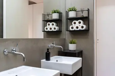 a bathroom with two sinks and a mirror at The Mouzinho Penthouse in Porto