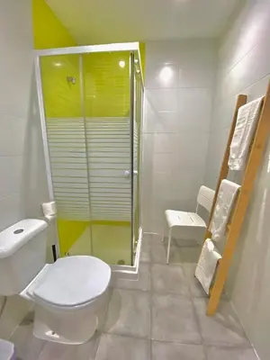 a bathroom with a toilet and a glass shower at Douro sunset lounge in Porto