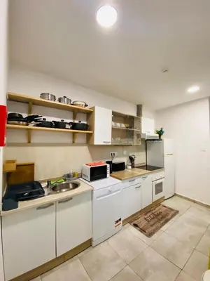 a kitchen with white cabinets and a sink at Douro sunset lounge in Porto