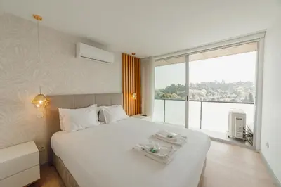 a bedroom with a large white bed with a large window at Amazing Pool Apartments by Vacationy in Vila Nova de Gaia