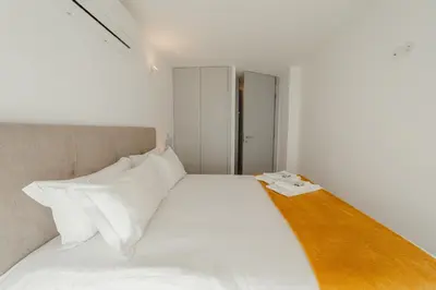 a bedroom with a large white bed with white pillows at Amazing Pool Apartments by Vacationy in Vila Nova de Gaia