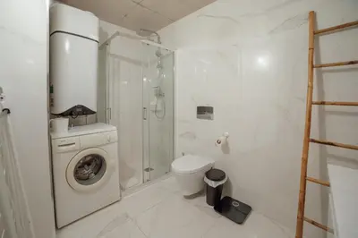 a bathroom with a washing machine and a shower at Amazing Pool Apartments by Vacationy in Vila Nova de Gaia