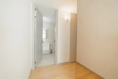 a hallway with white walls and wooden floors at Amazing Pool Apartments by Vacationy in Vila Nova de Gaia