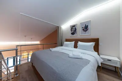 a bedroom with a large bed and a balcony at Paraíso Apartment by Amber Star Rent in Porto
