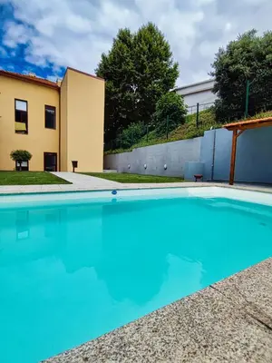 a swimming pool in front of a house at WLoft in Vila Nova de Gaia