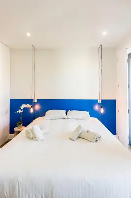 a large white bed with two pillows on it at Guest H4U - Porto Bonfim Heroismo in Porto