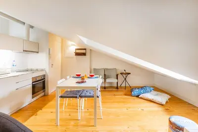 a bedroom with white cabinets and a bed at Oporto Loft with Mezzanine in Porto