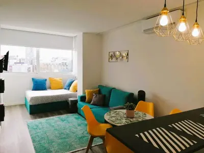 a living room with a blue couch and a table at Hey Porto Apartment in Porto