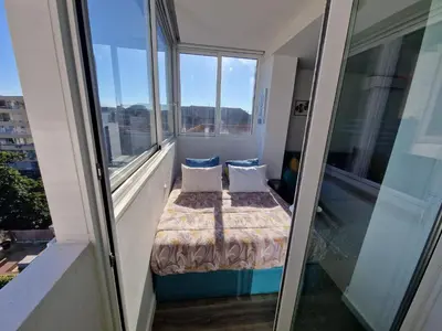 a small room with a bed and two pillows at Hey Porto Apartment in Porto