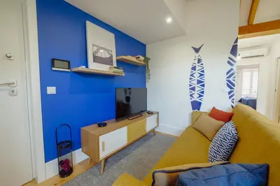 a living room with a couch and a blue wall at Downtown Prime With Terrace by Vacationy in Porto
