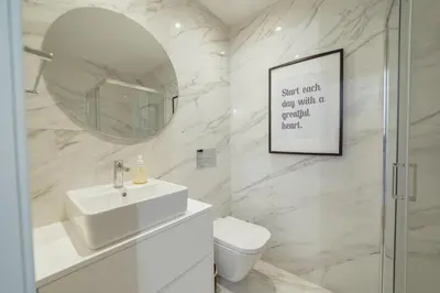 a white bathroom with a sink and a mirror at Downtown Prime With Terrace by Vacationy in Porto