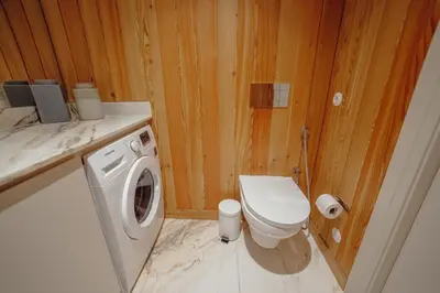 a bathroom with a toilet and a washing machine at Downtown Penthouse With River View by Vacationy in Porto