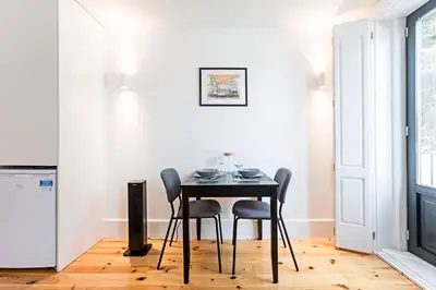 a dining room with a table and chairs at Lapa Flat in City Center by LovelyStay in Porto